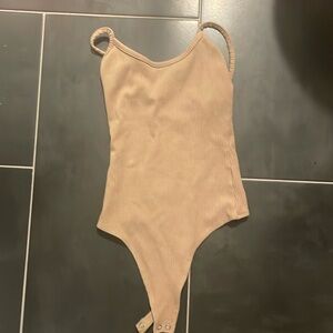 Tan colored body suit